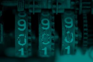 An analogue three-digit number counter, tinted green