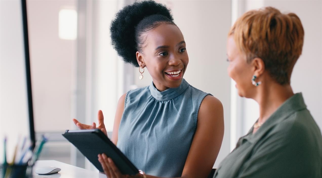 two women smiling and discussing 