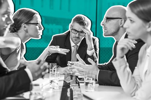 Group of people sat around a table arguing