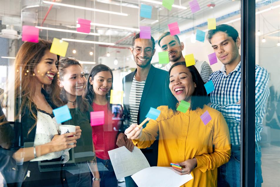 Employees in the office learning with post-it notes