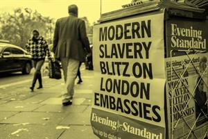 Close up of a newspaper stand on a pavement