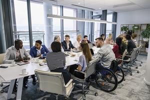 Diverse group of people sat in a meeting room