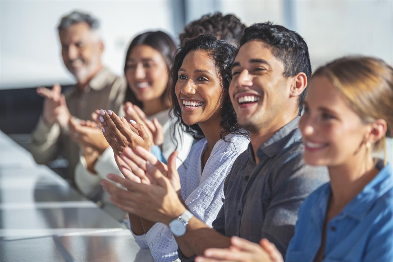 Group of happy employees clapping