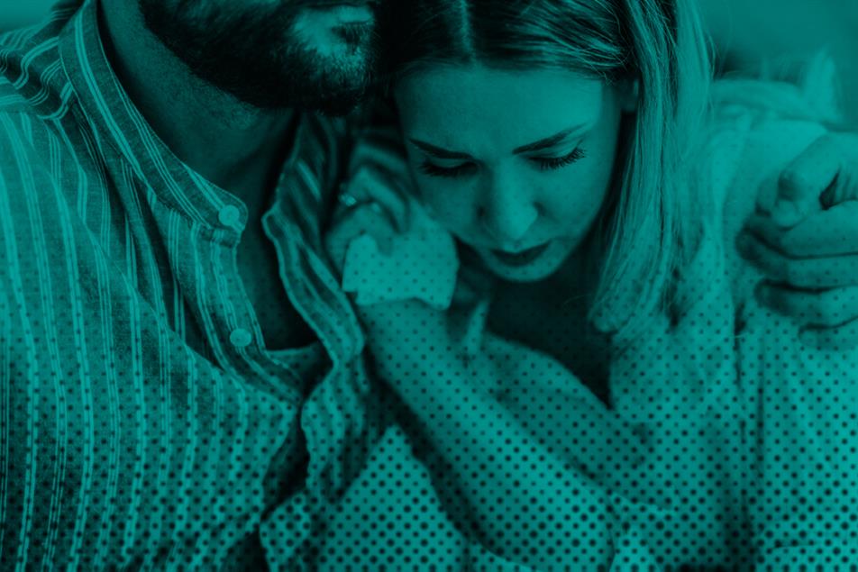 Person with their arm around someone holding a tissue