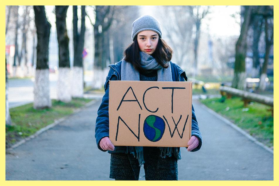 Person holding Act Now sign