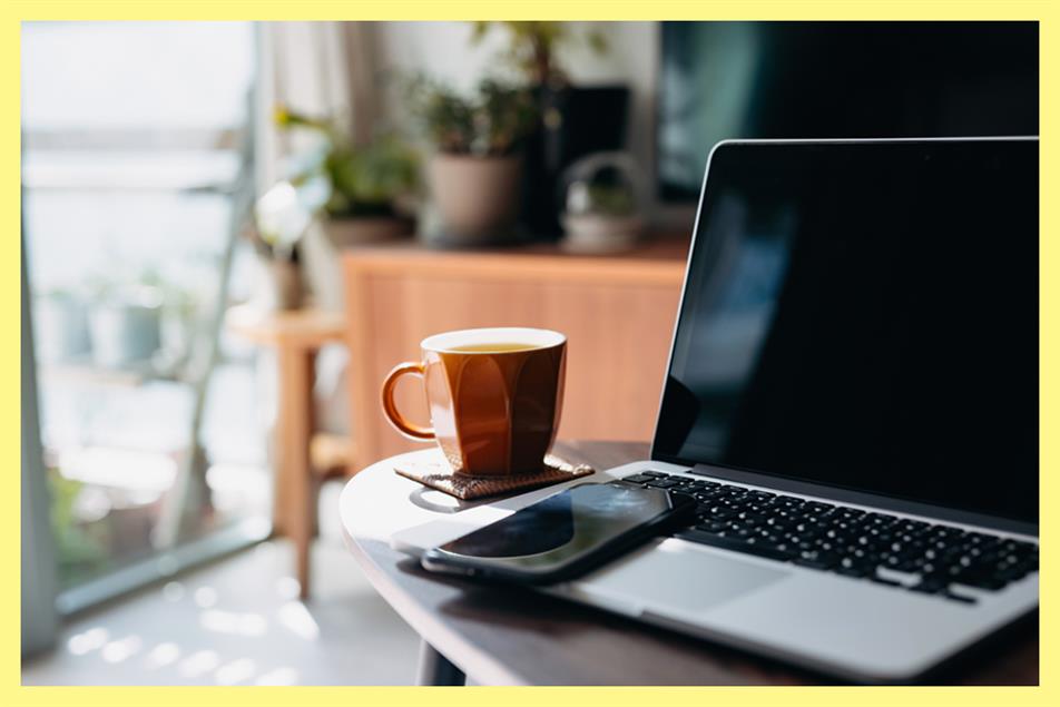 Laptop, phone and coffee cup on a table