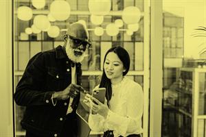 Two people looking at a phone