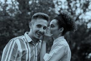 Person whispering in another person's ear