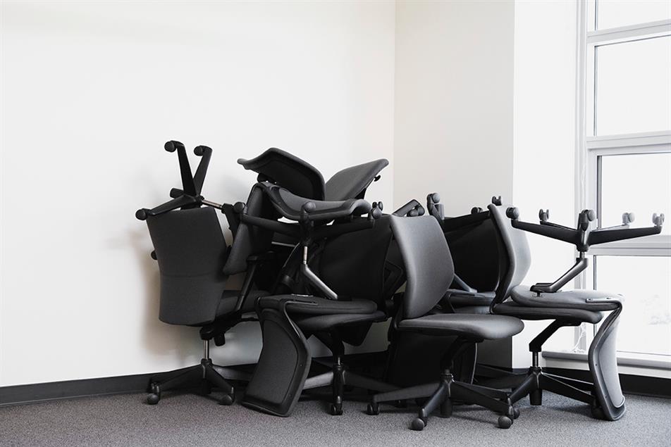 office chairs piled in corner