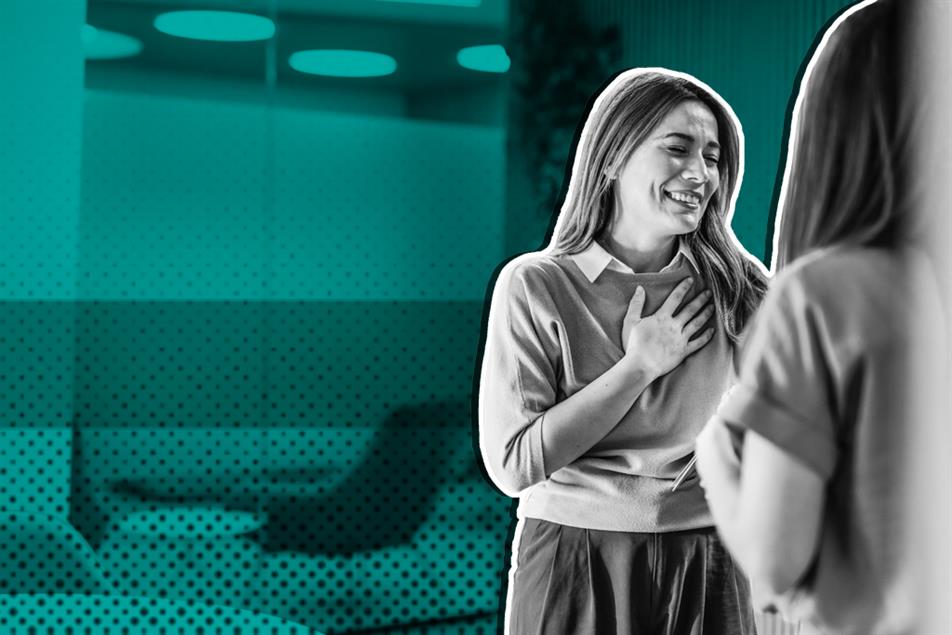 Grateful businesswoman thanking her colleague for good news in the office