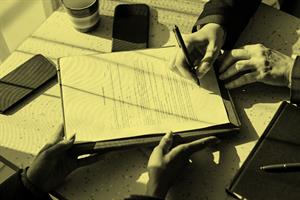 Close up of someone signing a contract