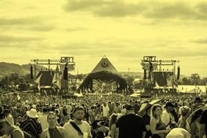 Image of a crowd of festival attendees in front of the pyramid stage at Glastonbury