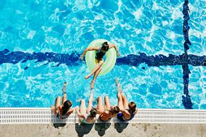 five women relaxing by the pool