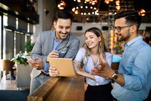 Group of workers discussing content on ipad
