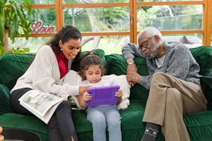 Woman, grandparent and child on sofa