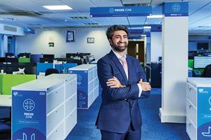 Usman Malik standing in an office