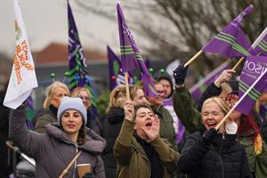 Group of people standing outside holding flags
