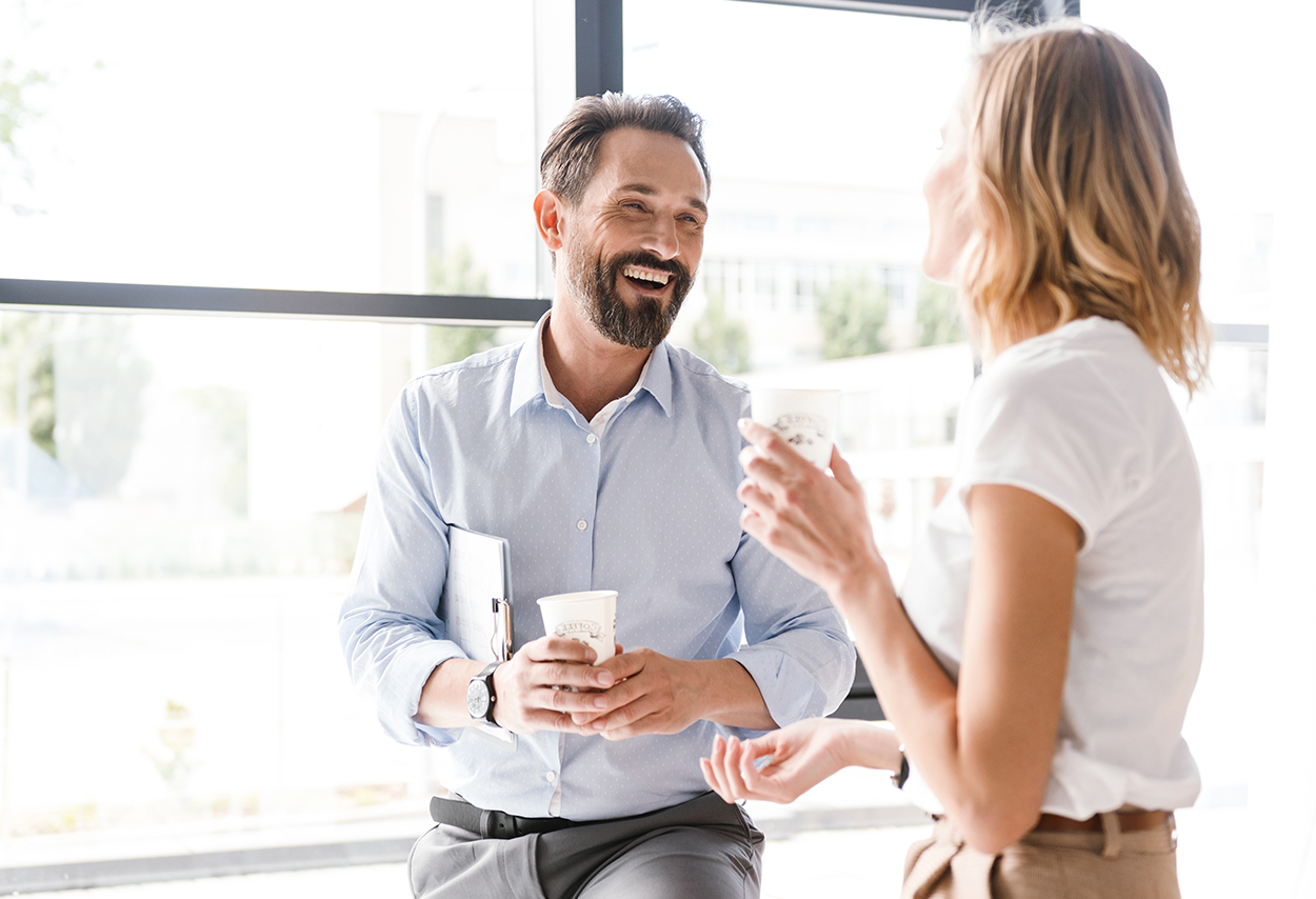 Two colleagues happily chatting