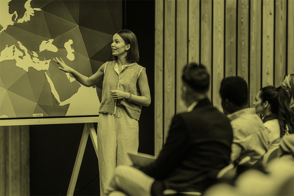 Person stood up presenting in front of a group of people