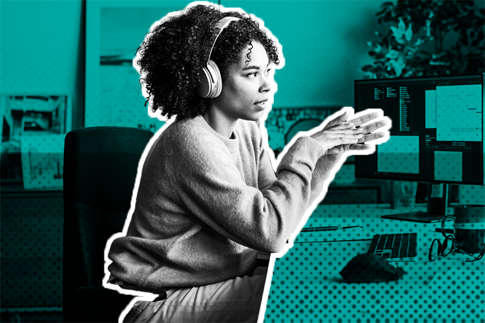 Person sat with headphones on in front of computer screen