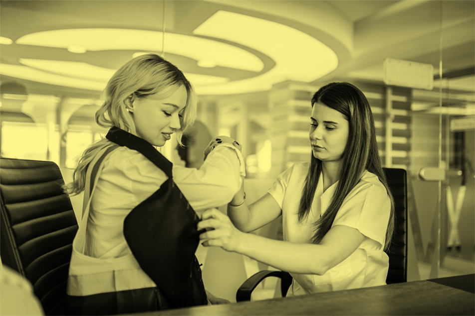 Healthcare worker helping someone with an arm sling