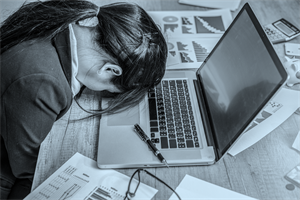 Person lying their head on a laptop