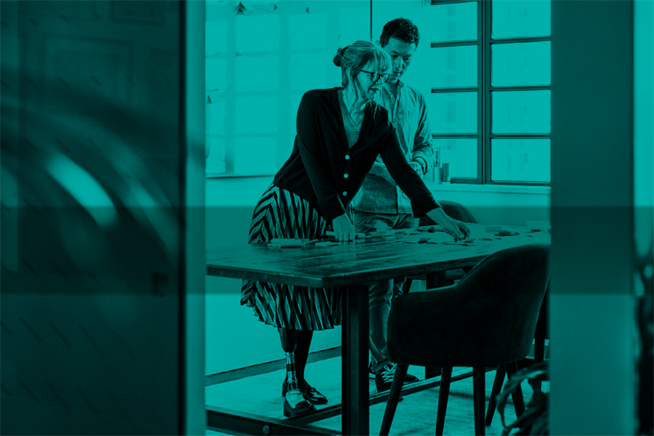 Two people standing at a desk