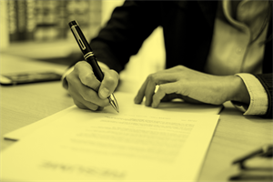 Close up of someone signing a document