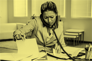 Person sat at a desk on the phone