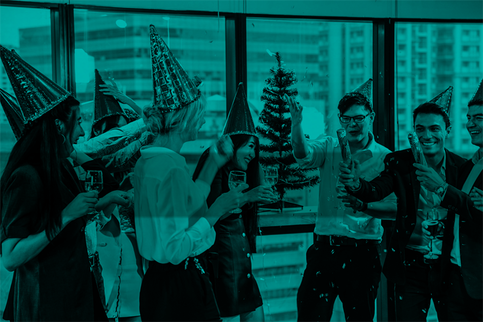 Group of people wearing Christmas hats and holding glasses and crackers