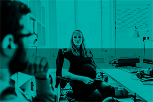 Two people sat talking in an office