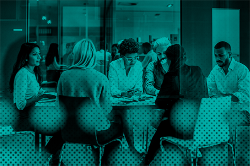 Group of people sat around a desk