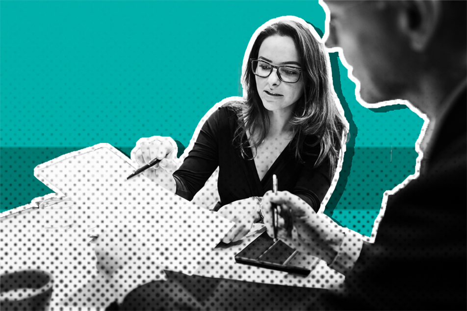 Two people holding documents and talking