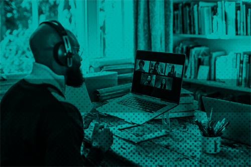 Man sat at desk at home in front of a laptop on a video call