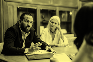 People sat around a table talking