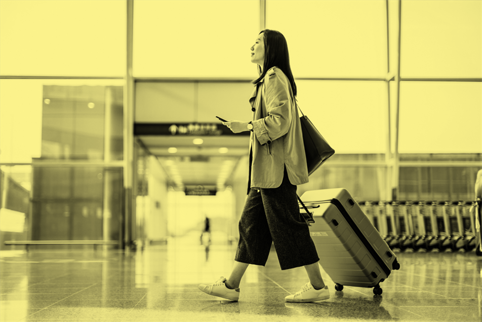 Person walking while pulling a suitcase