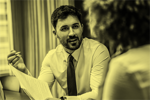 Person talking while holding a piece of paper