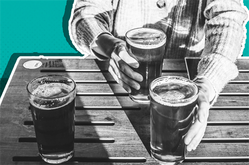 Close up of someone holding pints of beer