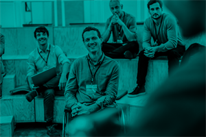 Group of people sat smiling and listening