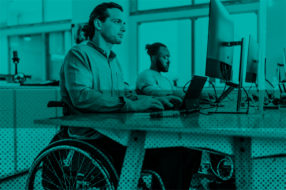 Person in a wheelchair at a desk