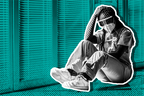 Nurse with head in hands