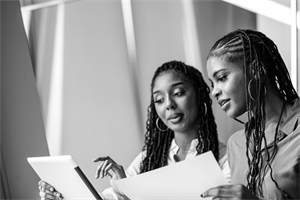 female worker being mentored by a female colleague 