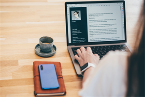 Woman writing CV on laptop
