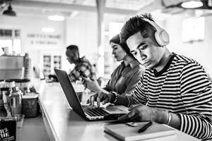 People sat at a desk with laptops