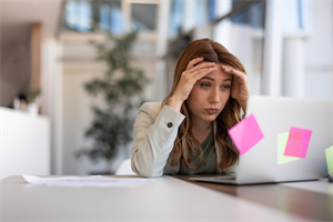 Woman looking stressed at her computer