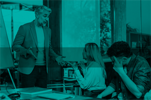 Person standing and arguing with person sat down in an office