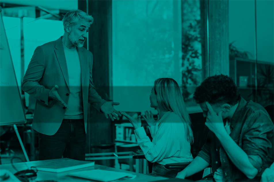 Person standing and arguing with person sat down in an office