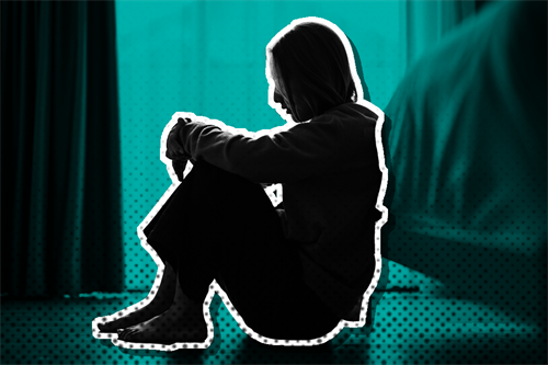 Person sat on the floor with legs drawn up