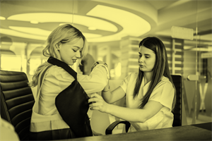 Healthcare worker helping someone with an arm sling