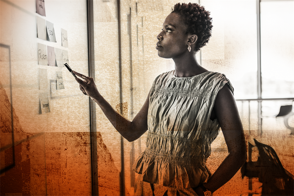 Person looking up at wall of post-it notes